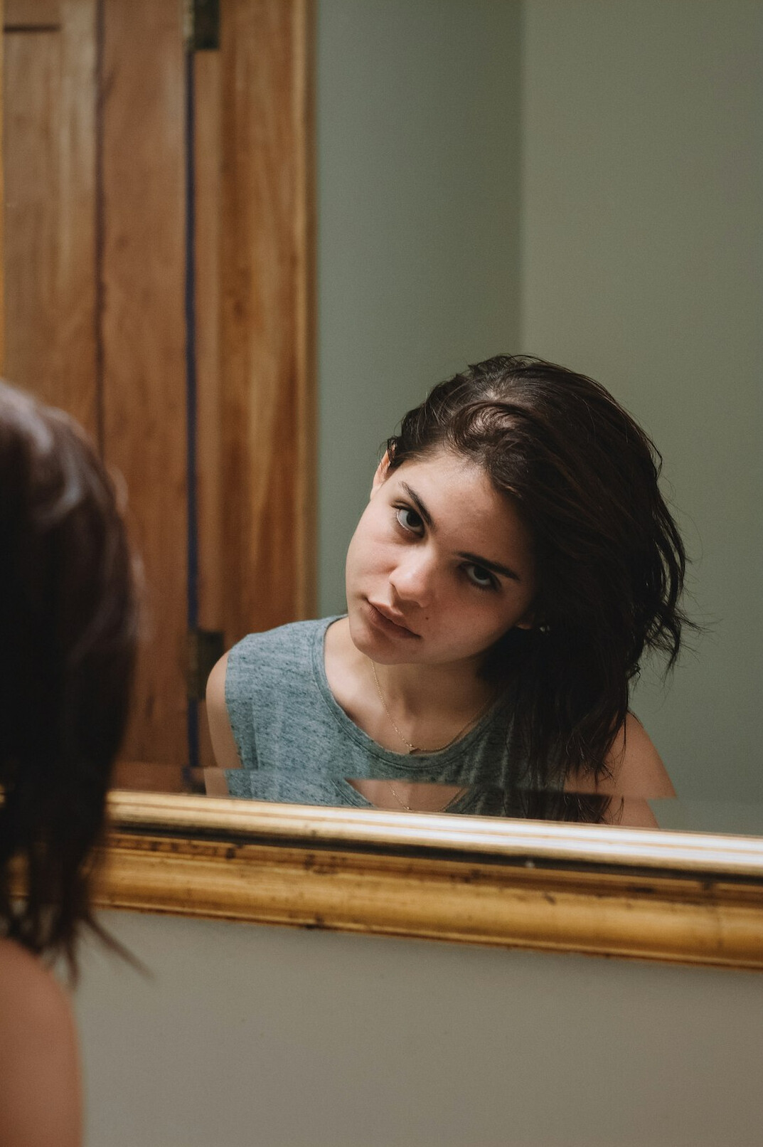 woman smiling confidently in mirror